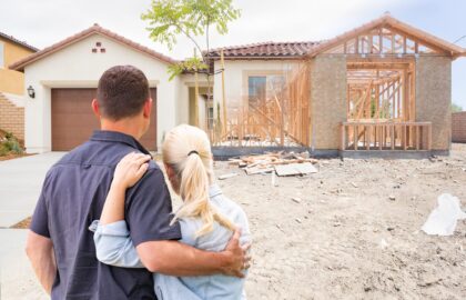 Couple Facing Construction Framing Gradating To Completed Home